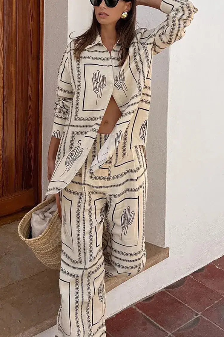 Woman in a stylish long sleeve lapel top and high waist wide leg pants suit with cactus print.