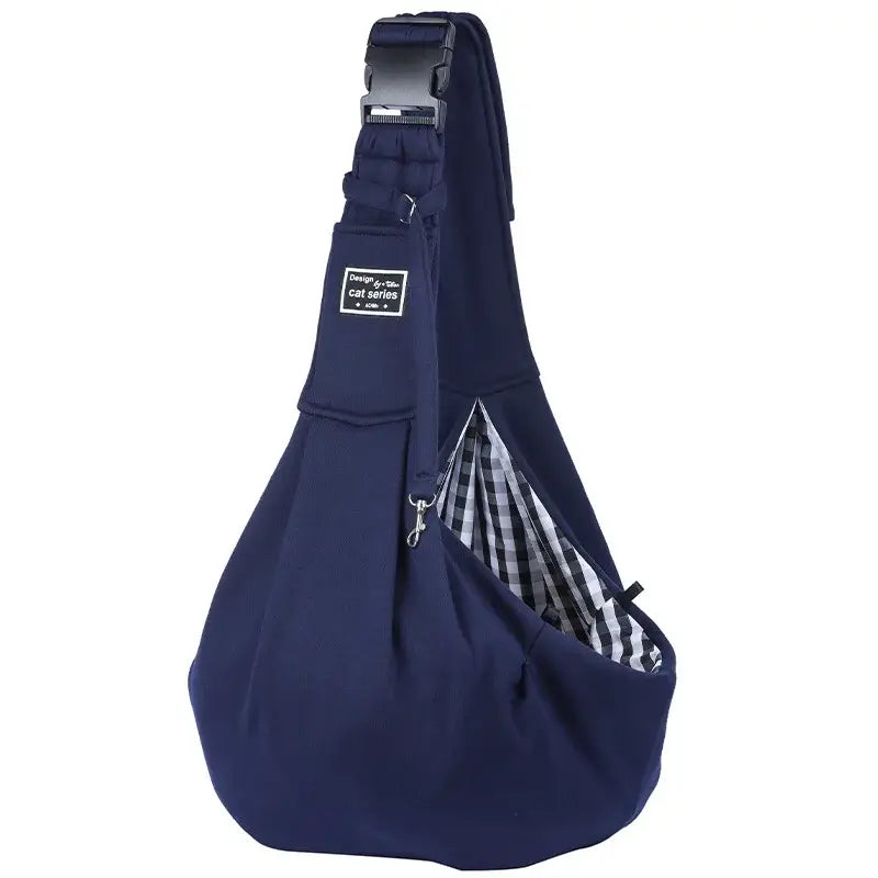 Navy blue pet carrier sling with adjustable shoulder strap and mobile phone pocket, designed for outdoor travel adventures.
